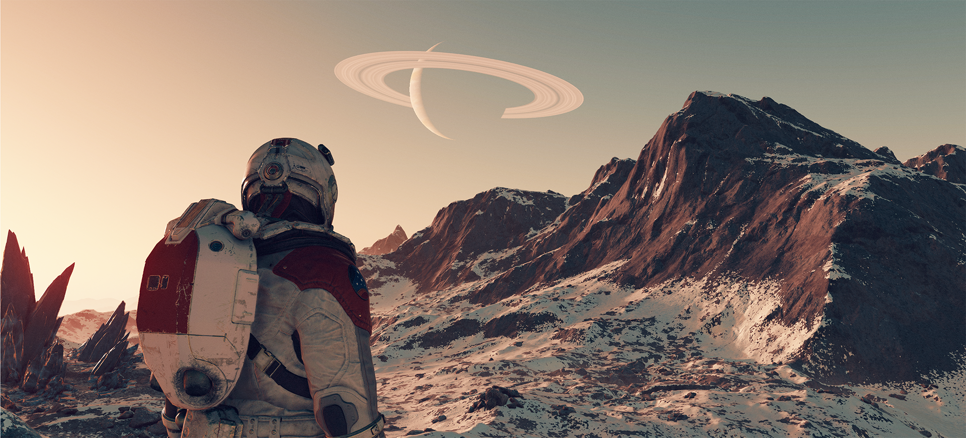 An in-game screenshot of Starfield with a ringed planet in the sky above nearby mountains and an astronaut in the foreground.